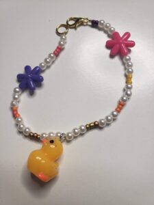 Pearl duck bracelet from Salish Rose with a pink star